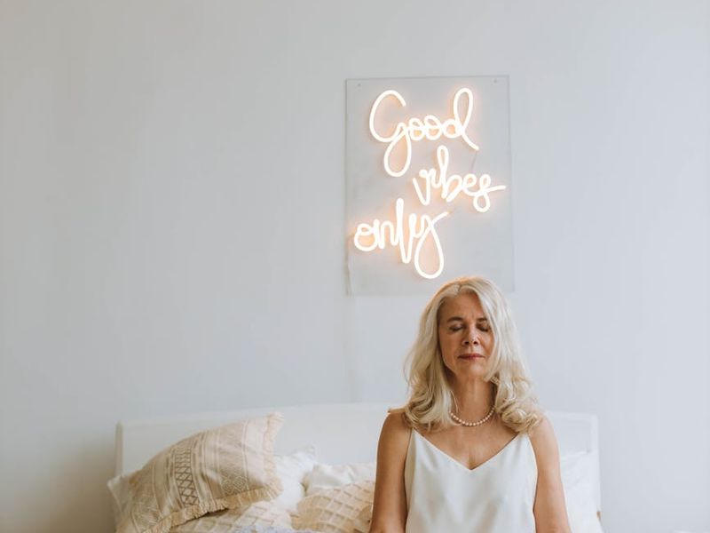 A person moving gracefully through a yoga sequence in a bright, minimalist room.